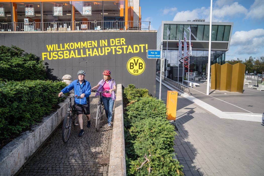 Das Foto zeigt Fahrradfahrer am Fußballmuseum Dortmund
