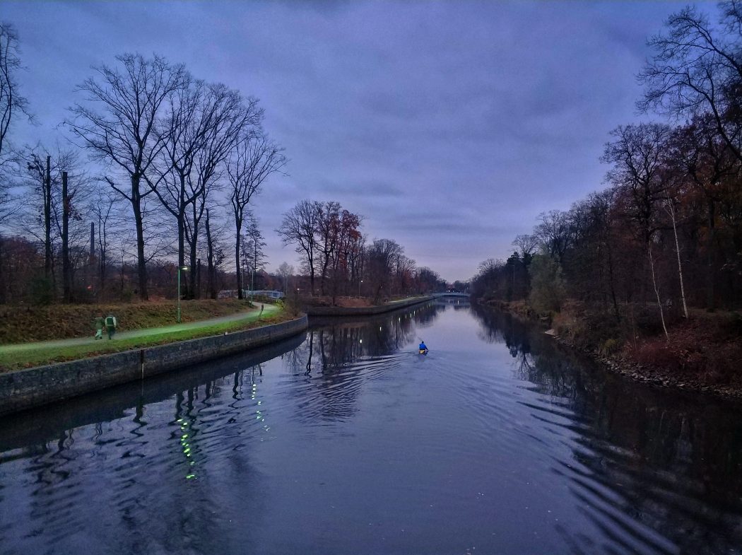 Das Bild zeigt einen Fluss mit Kanufahrer