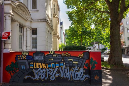 Das Foto zeigt die schönen Fassaden einiger Häuser und eine Graffiti-Wand im Dortmunder Kreuzviertel.