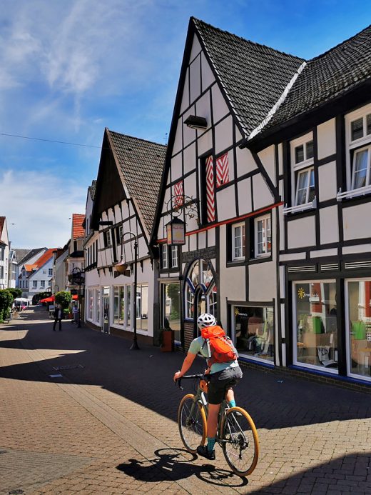 Das Foto zeigt Pascal vor schönen Fachwerkhäusern in Beckum